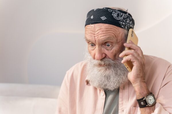 man experiencing phone scam