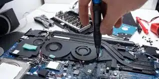 Technician repairing a laptop motherboard with tools in Romford.
